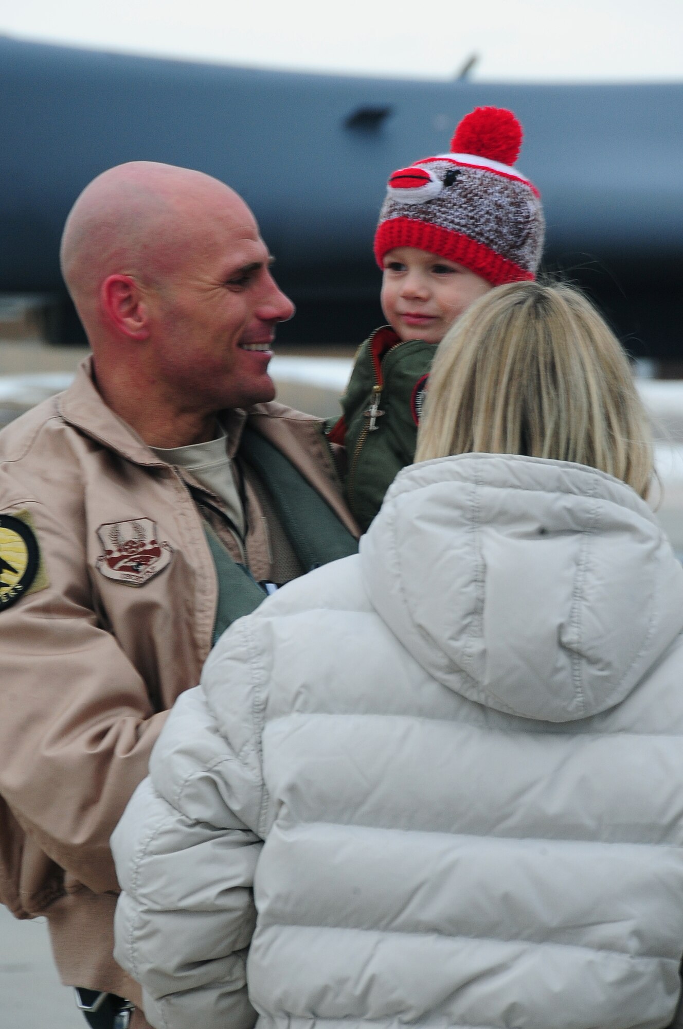 ELLSWORTH AIR FORCE BASE, S.D. -- Capt. Erick Lord, 37th Bomb Squadron weapons system officer, reunites with his wife and son after a six month deployment in Southwest Asia.  Capt. Lord returned from his deployment in support of Operation Iraqi Freedom and Operation Enduring Freedom. (U.S. Air Force photo/Airman 1st Class Anthony Sanchelli)
