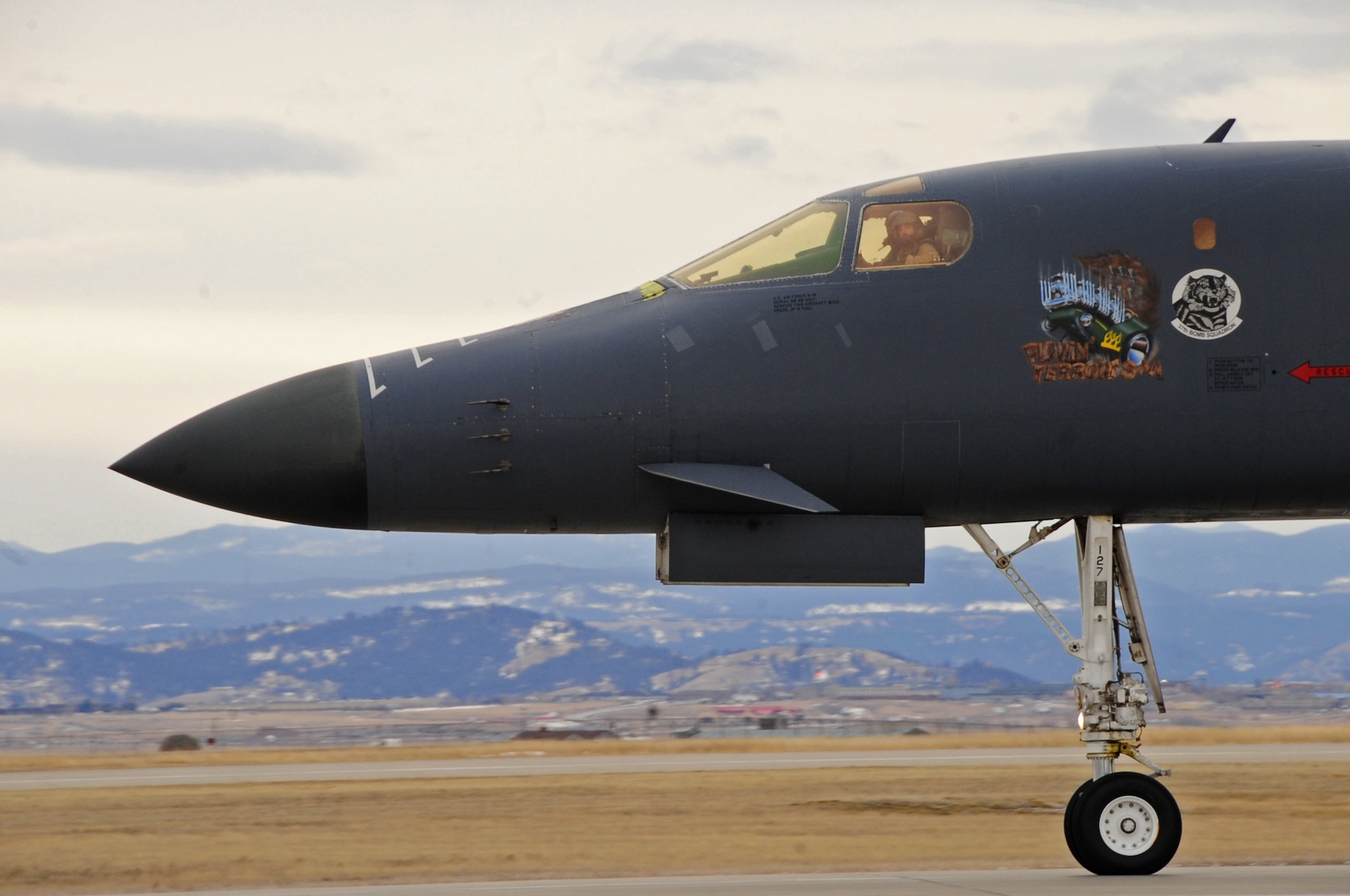 ELLSWORTH AIR FORCE BASE, S.D. -- A B-1B Lancer from the 37th Bomb Squadron lands after a six-month deployment in Southwest Asia, Jan. 26.  The B-1 can rapidly deliver massive quantities of precision and non-precision weapons against any adversary, anywhere in the world, at any time. (U.S. Air Force photo/Airman 1st Class Anthony Sanchelli)


