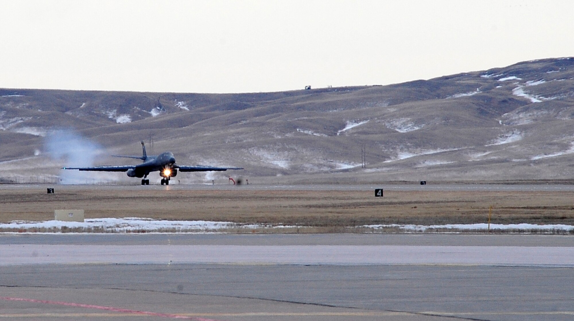 ELLSWORTH AIR FORCE BASE, S.D. -- A B-1B Lancer from the 37th Bomb Squadron lands after a six-month deployment in Southwest Asia, Jan. 26.  The B-1 can rapidly deliver massive quantities of precision and non-precision weapons against any adversary, anywhere in the world, at any time. (U.S. Air Force photo/Airman 1st Class Anthony Sanchelli)

