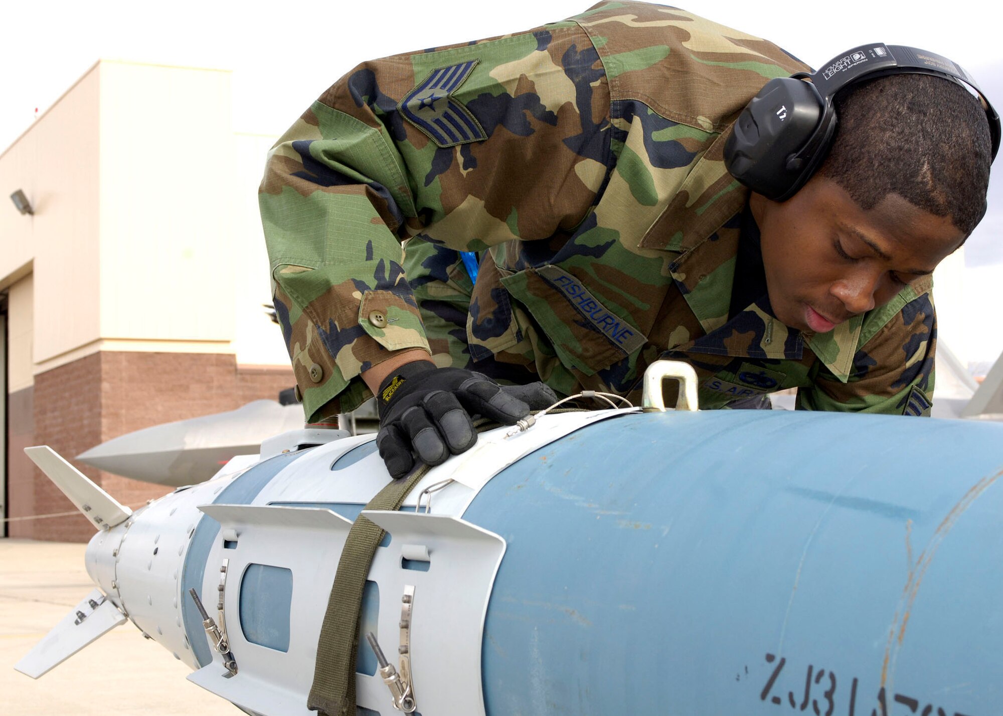 HOLLOMAN AIR FORCE BASE, N.M. -- Staff Sgt. Ernest Fishburne, 49th Aircraft Maintenance Squadron, secures a missile in preparation to load it on an F-22 Raptor during the Load Crew of the Year competition, Jan. 19. Sergeant Fishburne and his three-man crew were one of four competing for the title. (U.S. Air Force photo by Senior Airman DeAndre Curtiss)