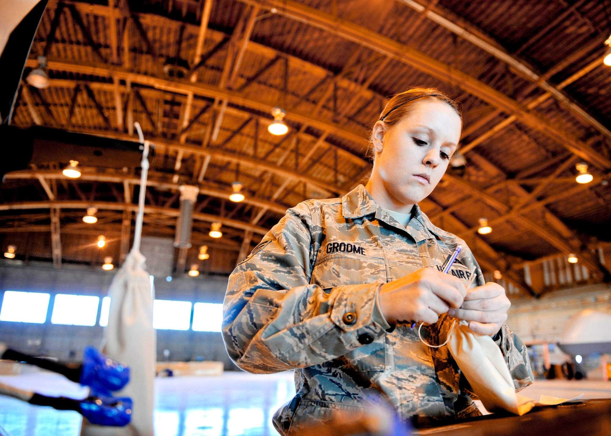 Senior Airman Stephanie Groome puts hardware into a bag, labels it and assigns it to the correct wing to ensure the hardware isn't lost during transportation, Jan. 17, 2010, at Holloman Air Force Base, N.M. Airman Groome is a crew chief assigned to the 849th Aircraft Maintenance Squadron. (U.S. Air Force photo/Staff Sgt. Anthony Nelson Jr.)