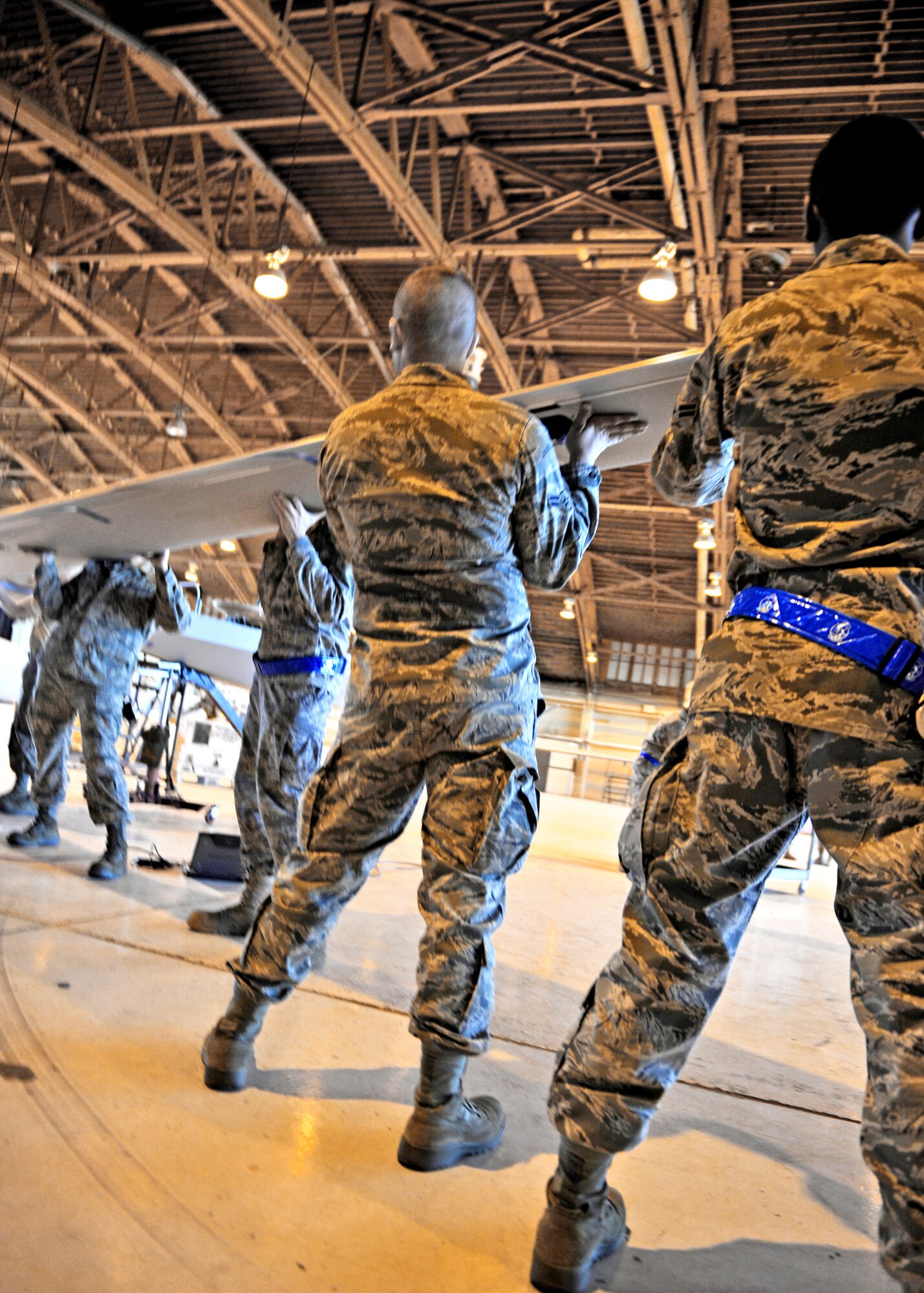 Airmen from the 849th Aircraft Maintenance Squadron remove the right wing of an MQ-1 Predator, Jan. 17, 2010, at Holloman Air Force Base, N.M. The Airmen dissembled and packaged a Predator for departure in support of Operation Unified Response. (U.S. Air Force photo/Staff Sgt. Anthony Nelson Jr.)