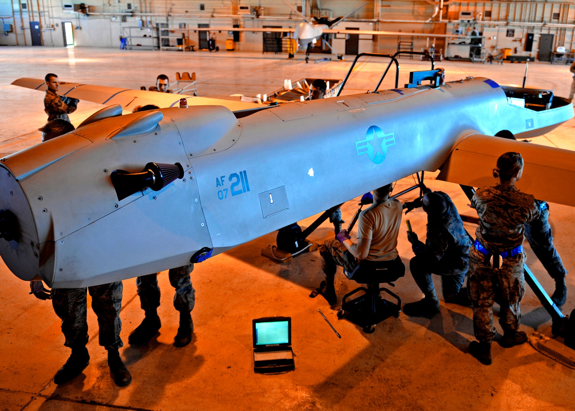 Airmen from the 849th Aircraft Maintenance Squadron disassemble an MQ-1 Predator in preparation for departure in support of Operation Unified Response Jan. 17, 2010, at Holloman Air Force Base, N.M. (U.S. Air Force photo/Staff Sgt. Anthony Nelson Jr.)