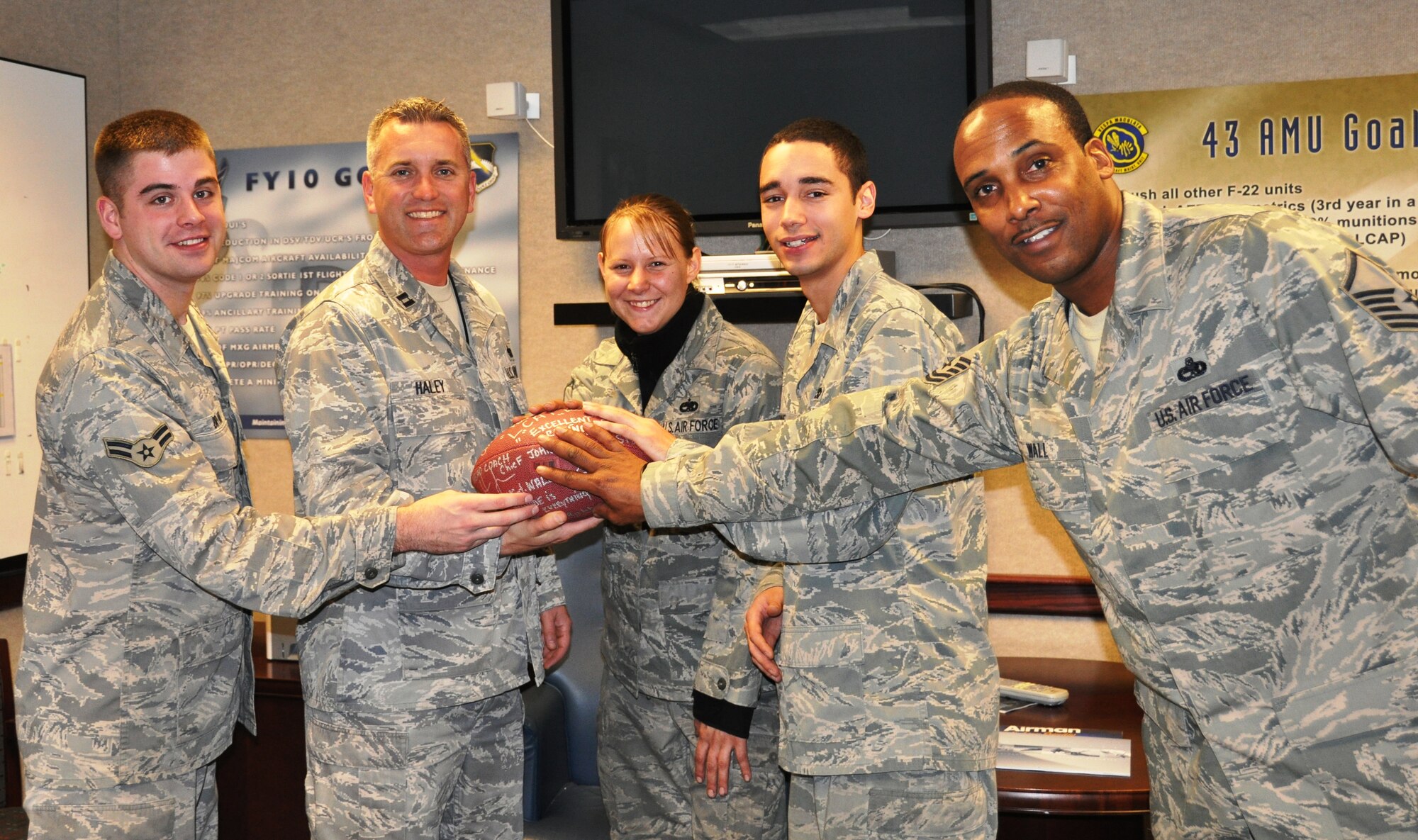 Capt. Chris Haley, 43rd AMU Officer in Charge, and Master Sgt. Stanley Wall, 43rd AMU crew chief, acted as the general manager and the head coach while recognizing three AMU personnel with 'LCAP Top Performer' game balls.  Of the 290 personnel in the AMU, 10 were recognized with the balls.  (U.S. Air Force photo/Senior Airman Veronica McMahon)