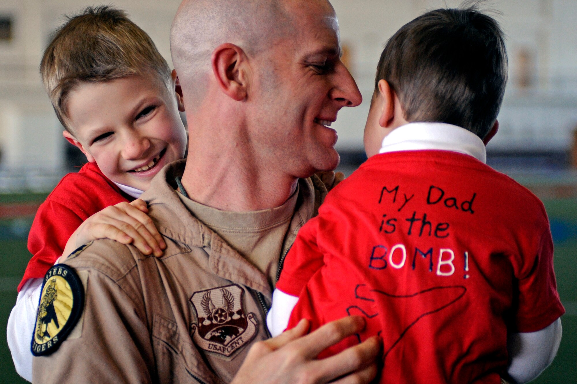 ELLSWORTH AIR FORCE BASE, S.D. -- Lt. Col. Derek Leivestad, 37th Bomb Squadron B-1B Lancer pilot, holds his children after returning from a deployment to Southwest Asia. While deployed to Southwest Asia, Colonel Leivestad provided support to Operations Iraqi Freedom and Enduring Freedom. (U.S. Air Force photo/Airman 1st Class Matthew Flynn)