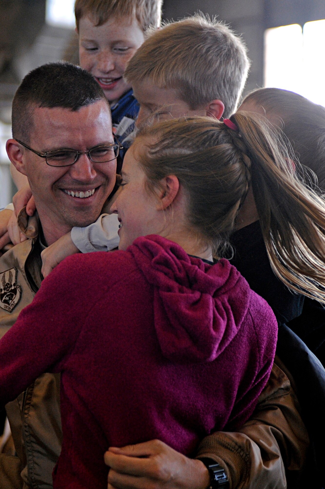 ELLSWORTH AIR FORCE BASE, S.D. -- Capt. Louis Heidema, 37th Bomb Squadron weapons systems officer, is swarmed by his children after returning home from his deployment, Jan. 27. While deployed, Captain Heidema provided support to Operations Iraqi Freedom and Enduring Freedom. (U.S. Air Force photo/Airman 1st Class Matthew Flynn)