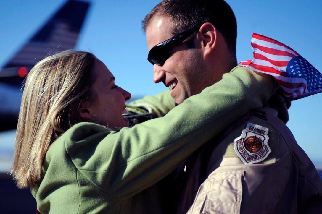 ELLSWORTH AIR FORCE BASE, S.D. -- Capt. Jason Corrigan, 37th Bomb Squadron B-1B Lancer pilot, hugs his girlfriend after returning from his deployment to Southwest Asia, Jan. 27.  While deployed to Southwest Asia, Captain Corrigan provided support to Operations Iraqi Freedom and Enduring Freedom. (U.S. Air Force photo/Airman 1st Class Matthew Flynn)