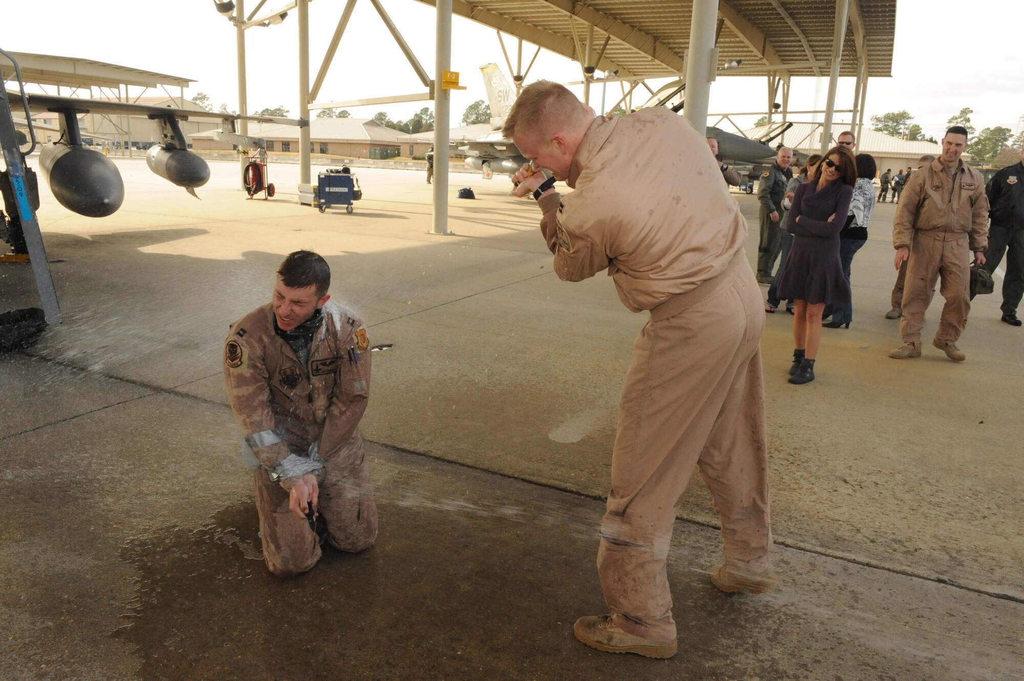 SHAW AIR FORCE BASE, S.C. -- Captain Jeff Shulman, 79th Fighter Squadron, is hosed down by Capt. Casey Manning, 79th FS, after his final, or "fini," flight home from Afghanistan Jan. 23. (U.S. Air Force Photo/Senior Airman David Minor)