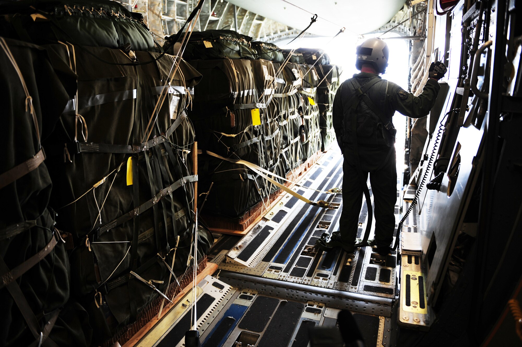 Staff Sgt. Matthew Shields, a C-17 Globemaster III loadmaster assigned to the 15th Airlift Squadron at Charleston Air Force Base, S.C., awaits the green light during an air delivery mission over Haiti in support of Operation Unified Response Jan. 21, 2010. The crew delivered 40 container delivery system bundles totaling 67,800 pounds of Meals, Ready to Eat and bottled water. (U.S. Air Force photo/Staff Sgt. Jacob N. Bailey)