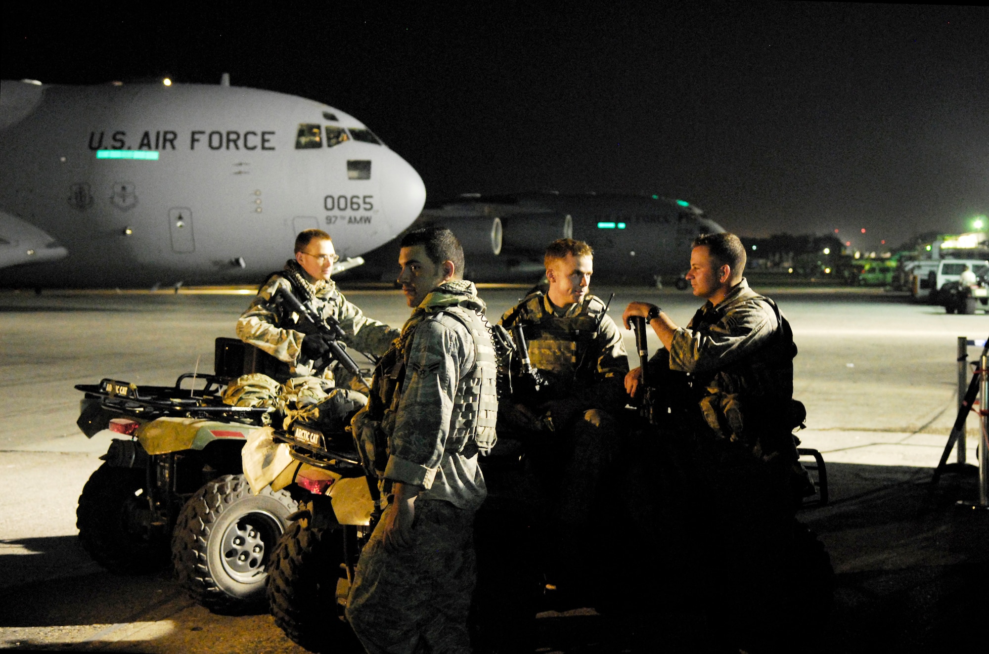 Airmen provide security on the flightline Jan. 19, 2010, at the Toussaint L'Ouverture International Airport in Port-au-Prince, Haiti. In addition to ramp security available on site, incoming Air Force aircraft typically carry a team of specially trained security forces personnel known as "Ravens" who provide security and overwatch during loading and unloading operations. (U.S. Air Force photo/1st Lt. Matt Schroff)