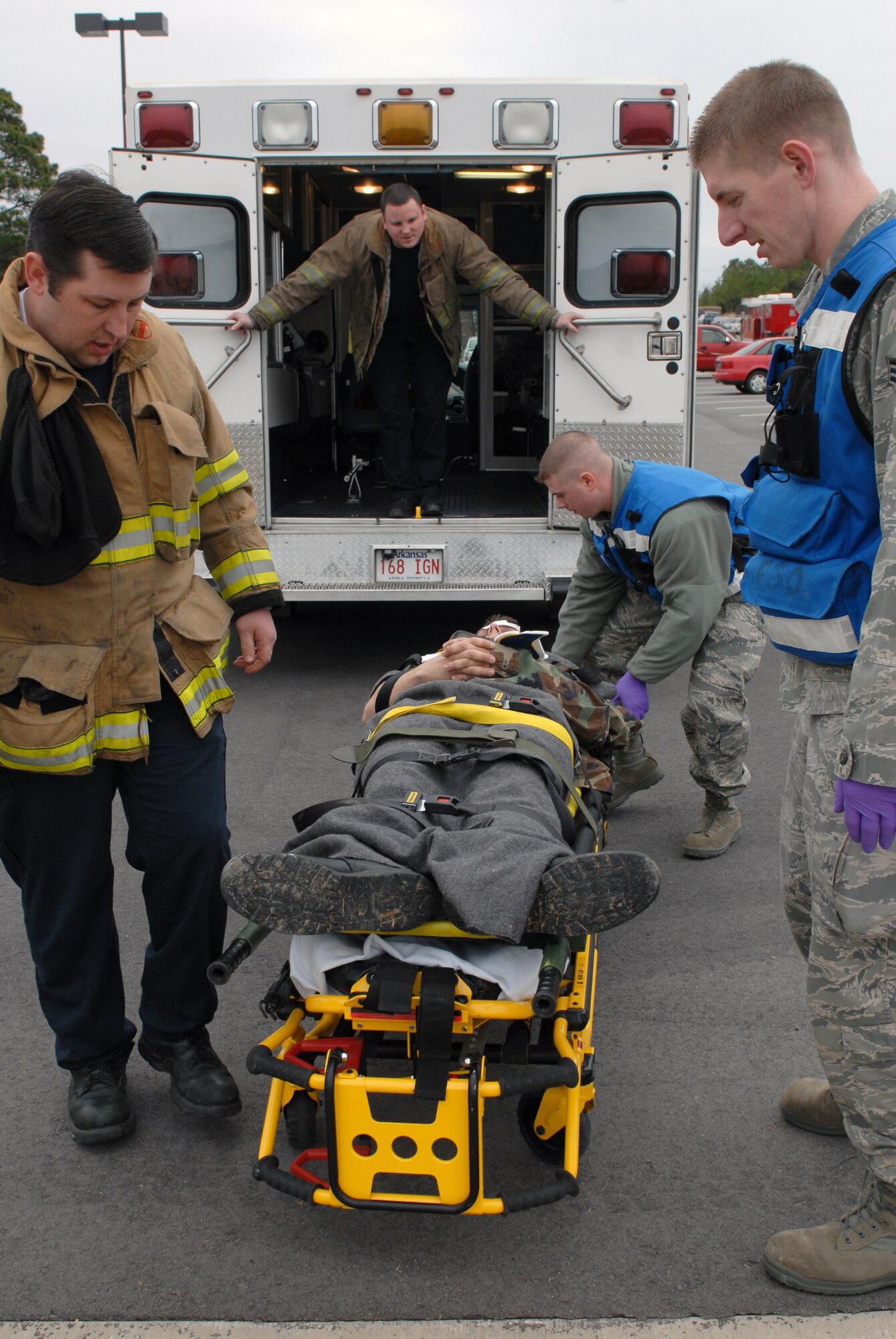 Little Rock Air Force Base medics and Jacksonville paramedics prepare to load a patient into an ambulance after a simulated explosion during a major accident response exercise Jan. 22. In a real-world event Jacksonville paramedics join Little Rock AFB in transferring patients. (U.S. Air Force photo by Senior Airman Christine Clark)
