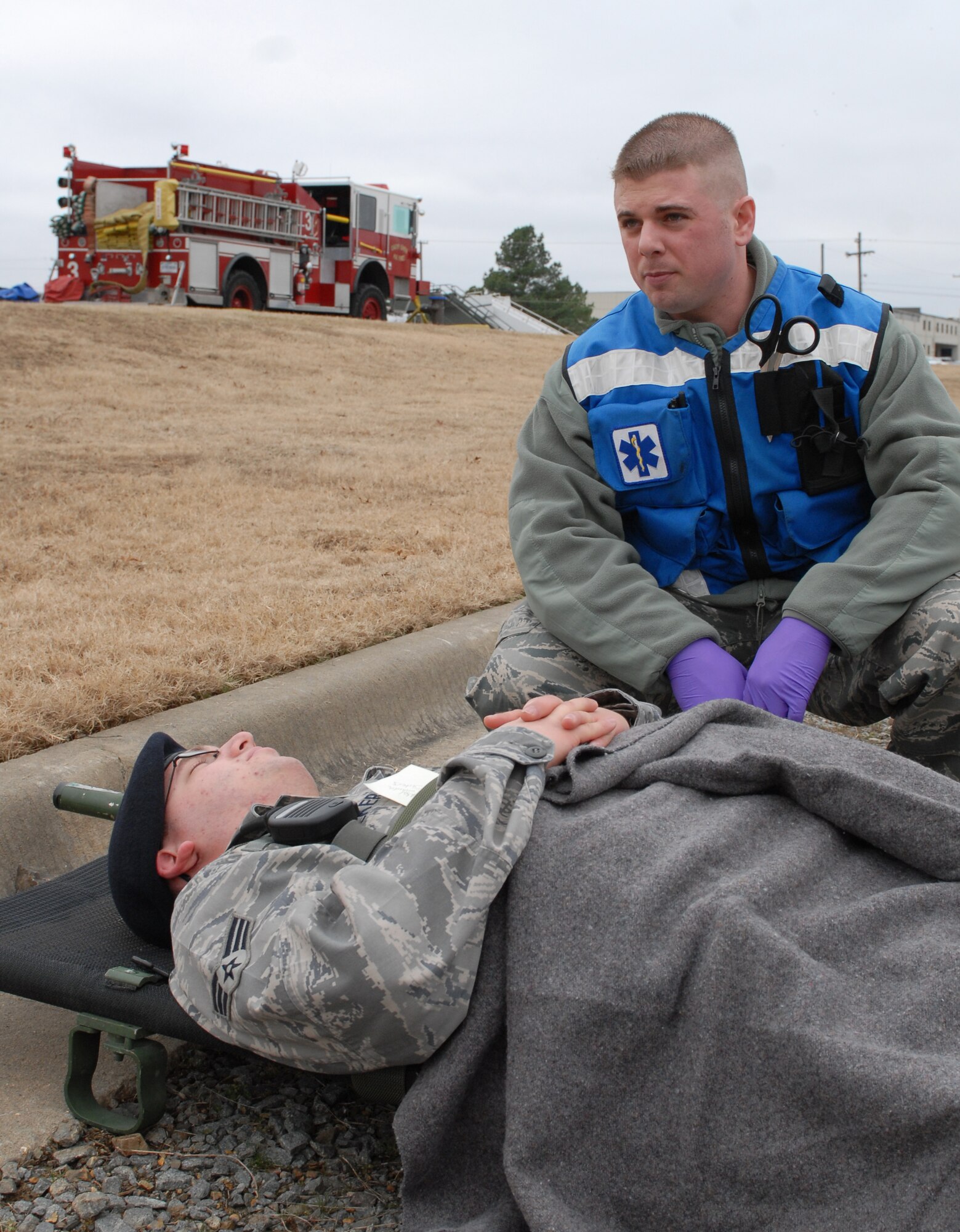 Staff Sgt. Derek Cowen, 19th Medical Group, tends to Senior Airmen Daniel Walker's simulated injuries after a simulated explosion during a major accident response exercise Jan. 22. Airmen perform a MARE every quarter with different scenarios. (U.S. Air Force photo by Senior Airman Christine Clark)
