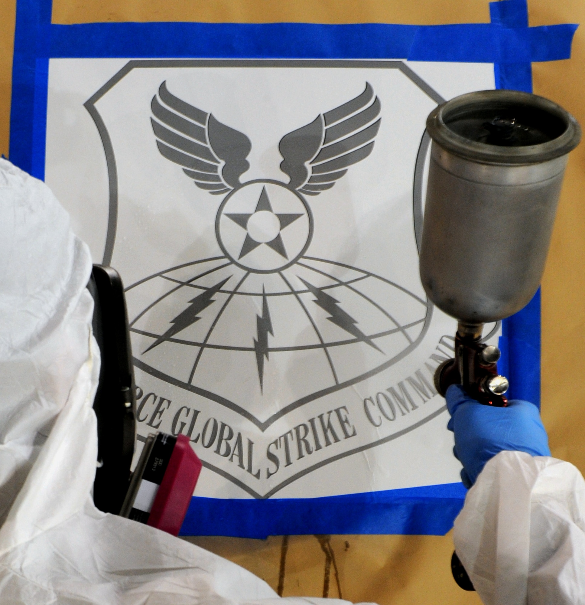 WHITEMAN AIR FORCE BASE, Mo. - Senior Airman Brian Neeley, 509th Maintenance Squadron structural maintenance and low-observable technician, sprays on a gray coat of LO material for the laying of the Air Force Global Strike Command patch,  here Jan. 27, 2010. On Feb. 1, 2010, Whiteman AFB and its arsenal of 20 B-2 bombers will change commands from Air Combat Command to AFGSC. The mission of AFGSC is to "develop and provide combat-ready forces for nuclear deterrence and global strike operations-- safe-- secure-- credible to support the President of the United States and combatant commanders." (U.S. Air Force photo by Airman 1st Class Carlin Leslie) (Released)




