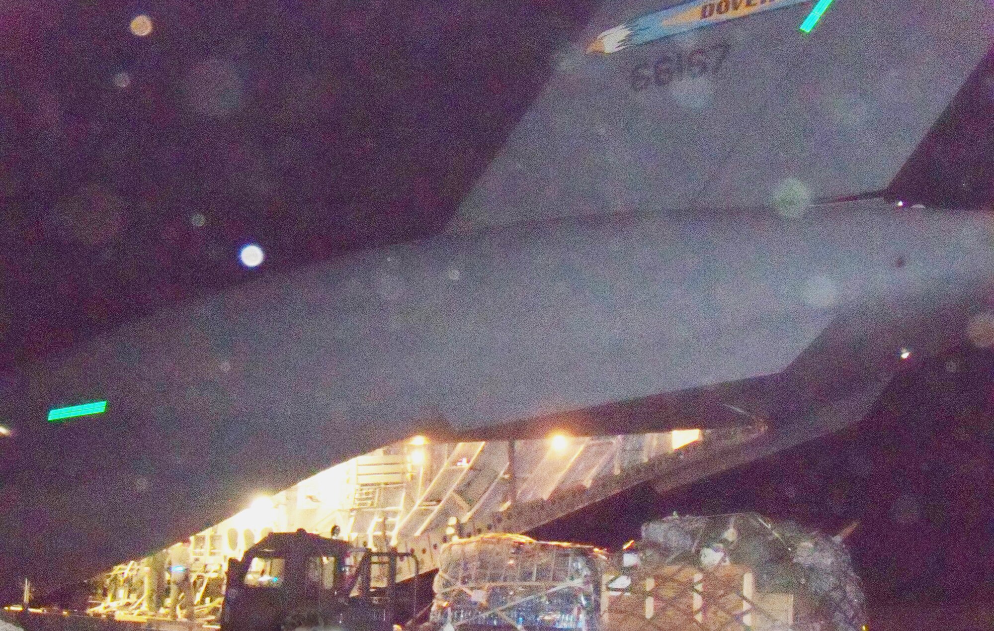 A C-17 Globemaster III crew from the 3rd Airlift Squadron at Dover Air Force Base, Del., drops off 90,000 pounds of disaster relief aid at the Port-au-Prince airport in Haiti on Jan. 19, 2010, in support of Operation Unified Response. After unloading the cargo, 36 evacuees boarded the aircraft which flew them to the U.S.  (U.S. Air Force photo/2nd Lt. Abigail Wise)