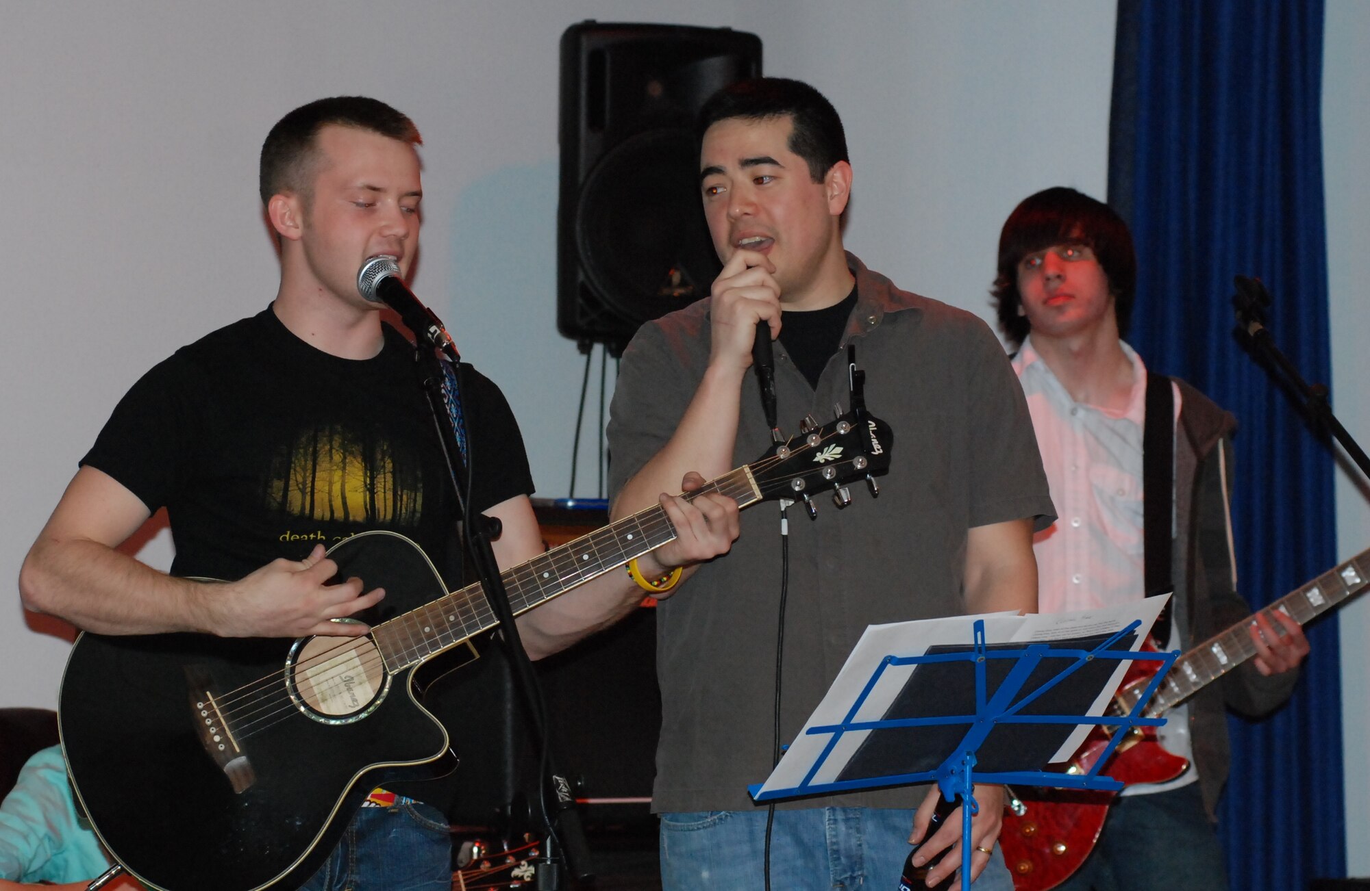 LAUGHLIN AIR FORCE BASE, Texas – Airman 1st Class Corey Davis, 47th Operations Support Squadron, left, is joined on guitar by Andrew Heppler, far right, while Tech. Sgt. Wesley McEuen, 47th Medical Operations Squadron sings at the first-ever jam session at Laughlin’s Club Amistad, Jan. 23. Six Airmen and a family member performed for more than two hours playing familiar rock songs. (U.S. Air Force photo by Tech. Sgt. Charlie Miller)