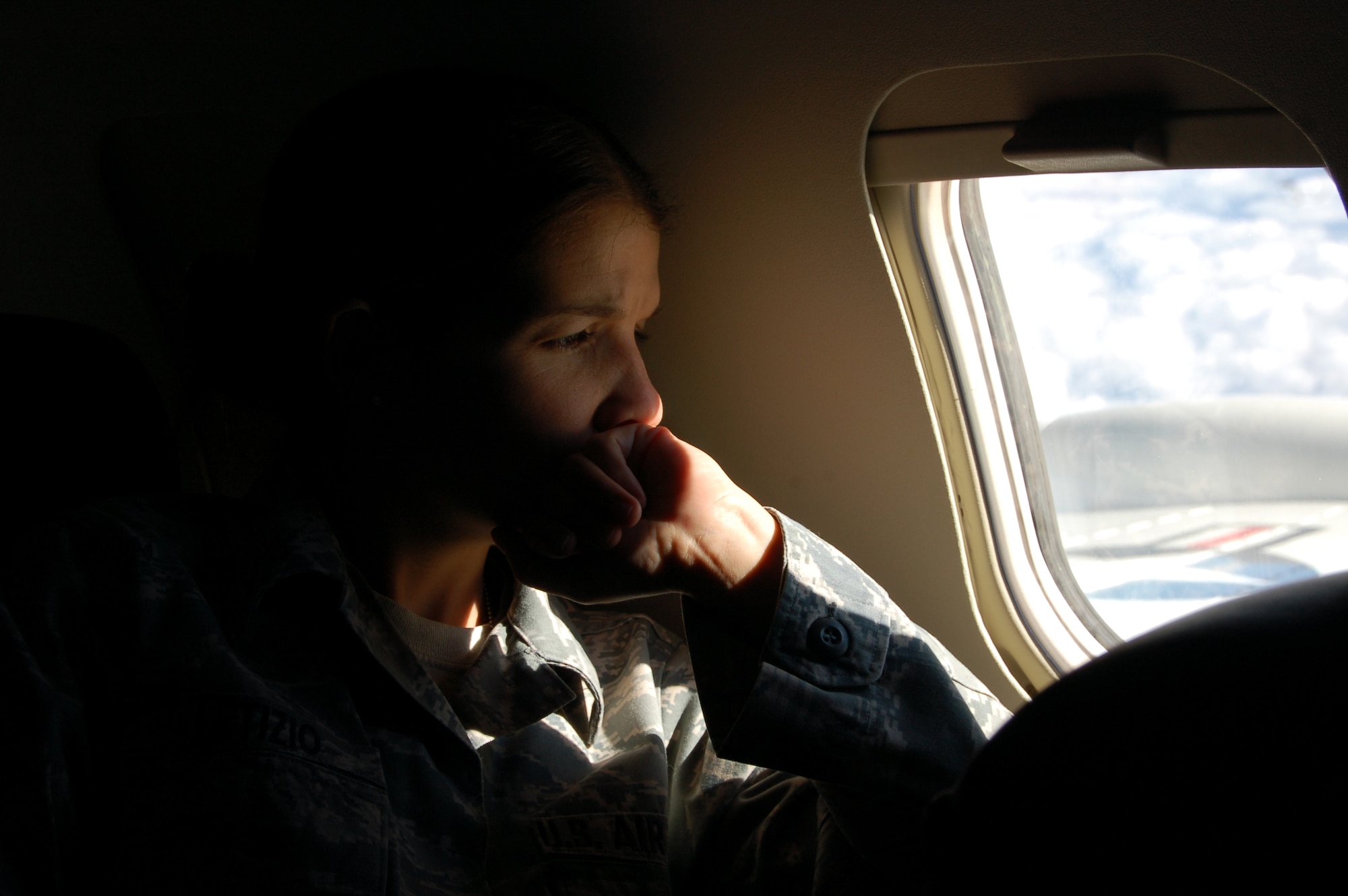 Master Sgt. Melissa Letizio, noncommissioned officer in charge of the Capt. Joseph Wadsworth Dining Hall takes in the view while aboard a C-21 transport plane heading to S.C. Jan. 25, 2010, where she will await transport to Haiti. Missy said she was anxious, wondering what the mission would include, but looking forward to help out in any way she can. (U.S. Air Force photo by Tech. Sgt. Joshua Mead)
