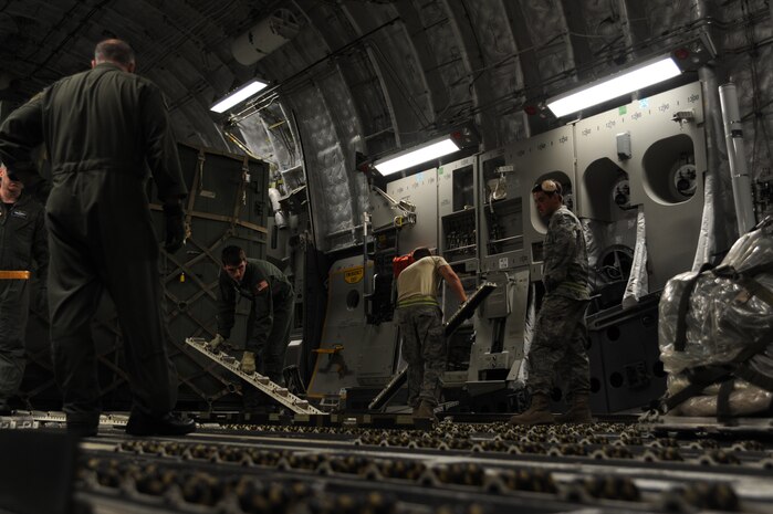 Air Force members flip rolling boards over after a special delivery of funds for the U.S. Embassy were delivered in Port-au-Prince, Haiti, Jan. 22, 2010. The emergency funds for the U.S. Embassy in Port-au-Prince were delivered after it lost the ability to perform electronic transactions. (U.S. Air Force photo/Senior Airman Katie Gieratz)(RELEASED)