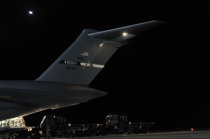 Relief supplies are unloaded from a Travis Air Force Base C-17 at Port-au-Prince, Haiti, Jan. 22, 2010. The aircraft departed from Charleston Air Force Base after being loaded with a special shipment of emergency funds for the U.S. Embassy in Port-au-Prince after it lost the ability to perform electronic transactions. (U.S. Air Force photo/Senior Airman Katie Gieratz)(RELEASED)