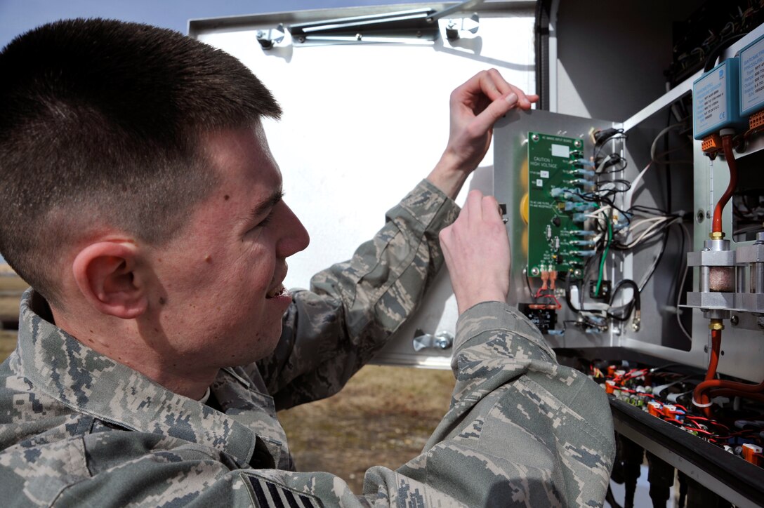 Staff Sgt. Gregory Honeywell, 744th Communication Squadron airfield systems technician, opens the main circuit panel on an automated weather system Jan. 21, 2010, at Joint Base Andrews. Sergeant Honeywell regularly performs preventive maintenance to ensure all equipment is running correctly. The Airmen of airfield systems maintenance perform maintenance for six bases in a 90-mile radius. (U.S. Air Force photo by Airman 1st Class Perry Aston)