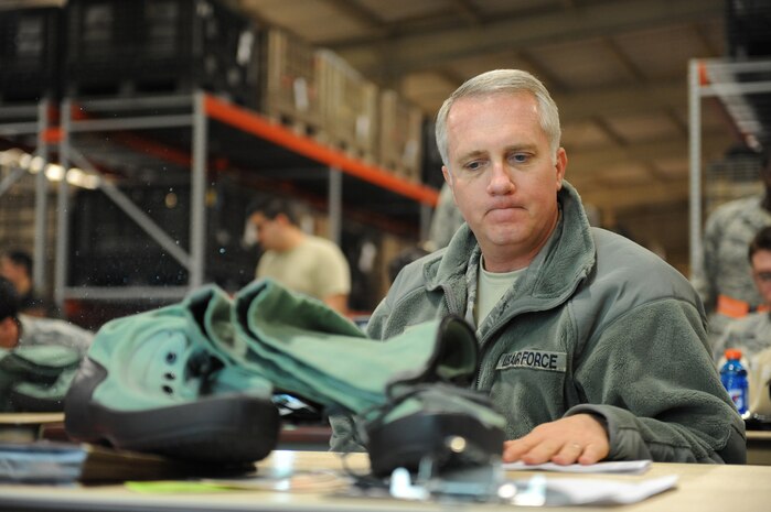 NELLIS AIR FORCE BASE, Nev. -- Col. Kevin Fox, Commander of the 99th Mission Support Group, performs an initial issue inspection on his cold weather bag during the 99th Air Base Wing Operational Readiness Inspection, Jan. 25.   (U.S. Air Force photo by Staff Sgt. Taylor Worley)