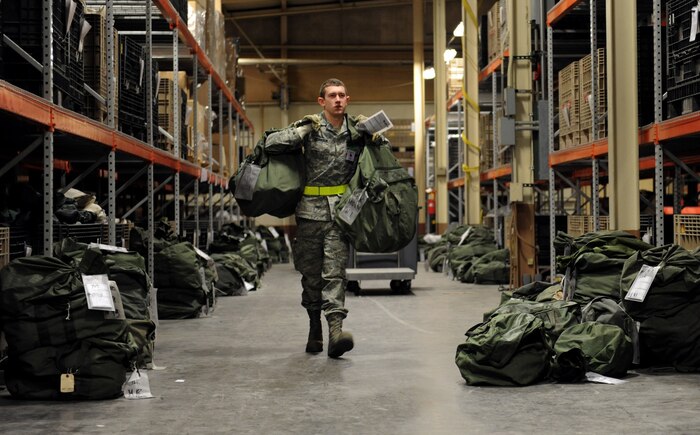 NELLIS AIR FORCE BASE, Nev. -- Airman 1st Class Robert Morrison, 99th Communications Squadron, gethers mobility bags to distribute to members processing the mobility line during the 99th Air Base Wing Operational Readiness Inspection, Jan. 25.   (U.S. Air Force photo by Staff Sgt. Taylor Worley)
