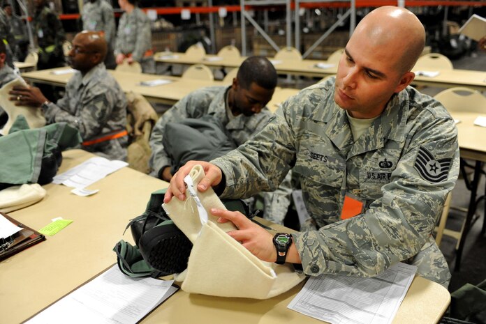 NELLIS AIR FORCE BASE, Nev. -- Tech. Sgt. Gregory Deets, 99th Communications Squadron, cross references the lot number on his cold weather gear against the hand receipt during the 99th Air Base Wing Operation Readiness Inspection Jan. 26. (U.S. Air Force photo by Tech. Sgt. Michael R. Holzworth)