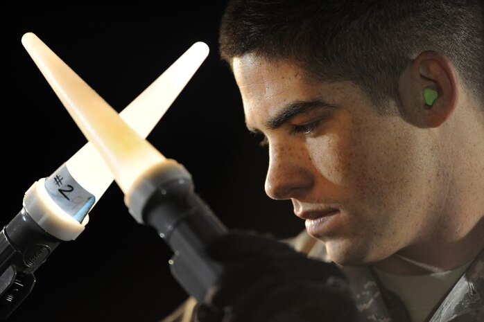 NELLIS AIR FORCE, Nev. -- Airman 1st Class Kaleb Salaza, 99th Logistics Readiness Squadron, marshals cargo on the flight line during the 99th Air Base Wing Operation Readiness Inspection Jan. 25. (U.S. Air Force photo by Tech. Sgt. Michael R. Holzworth)