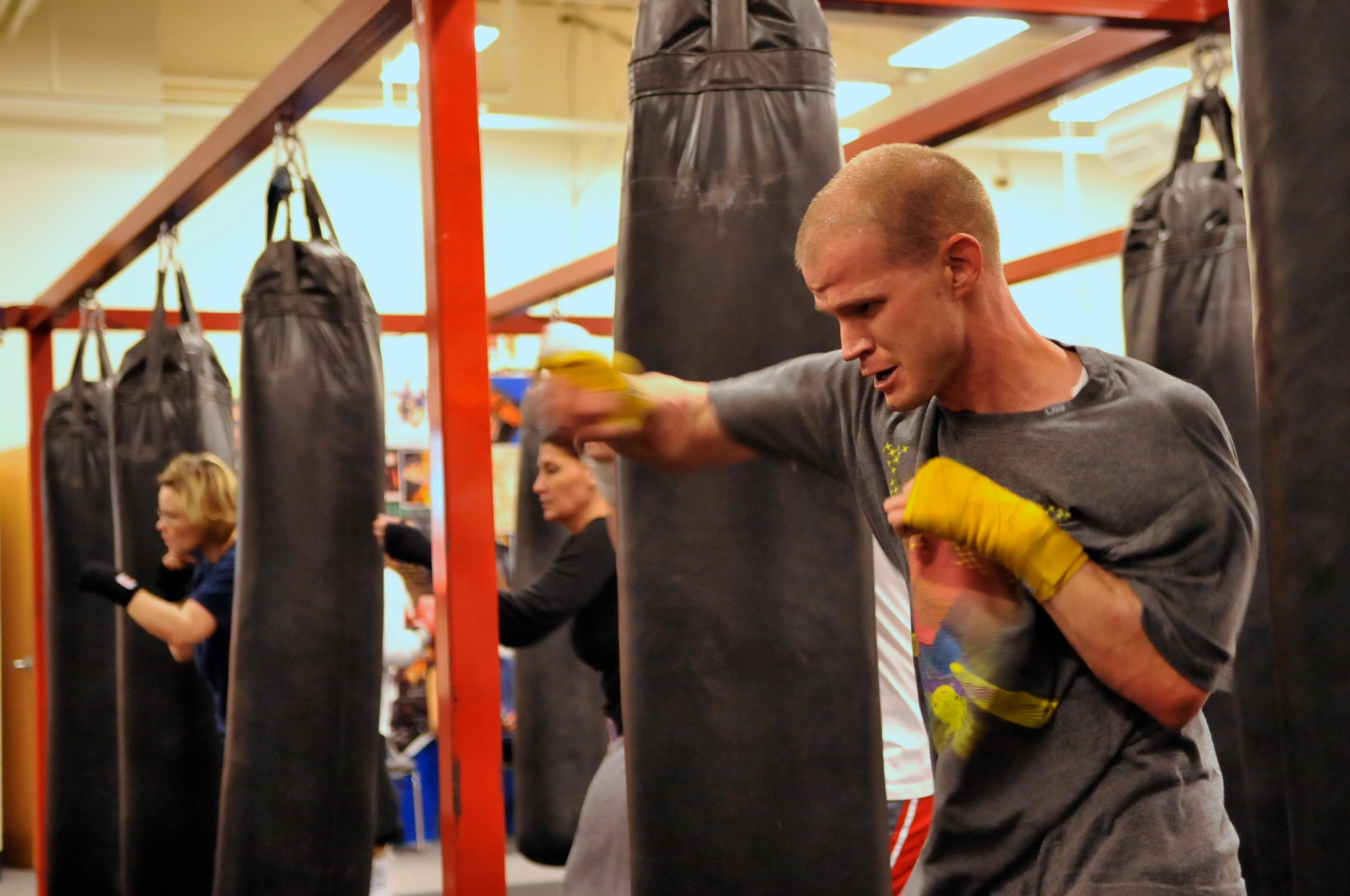 AURORA, Colo. -- Staff Sgt. Joshua Hinton, Air Reserve Personnel Center Directorate of Communications and Information knowledge operations manager, slugs it out during a fitness class at A1 Boxing Oct. 25. Boxing fitness programs are full body workouts that can burn 800 to 1,000 calories for every one hour session. (U.S. Air Force photo by Senior Airman Kathrine McDowell)