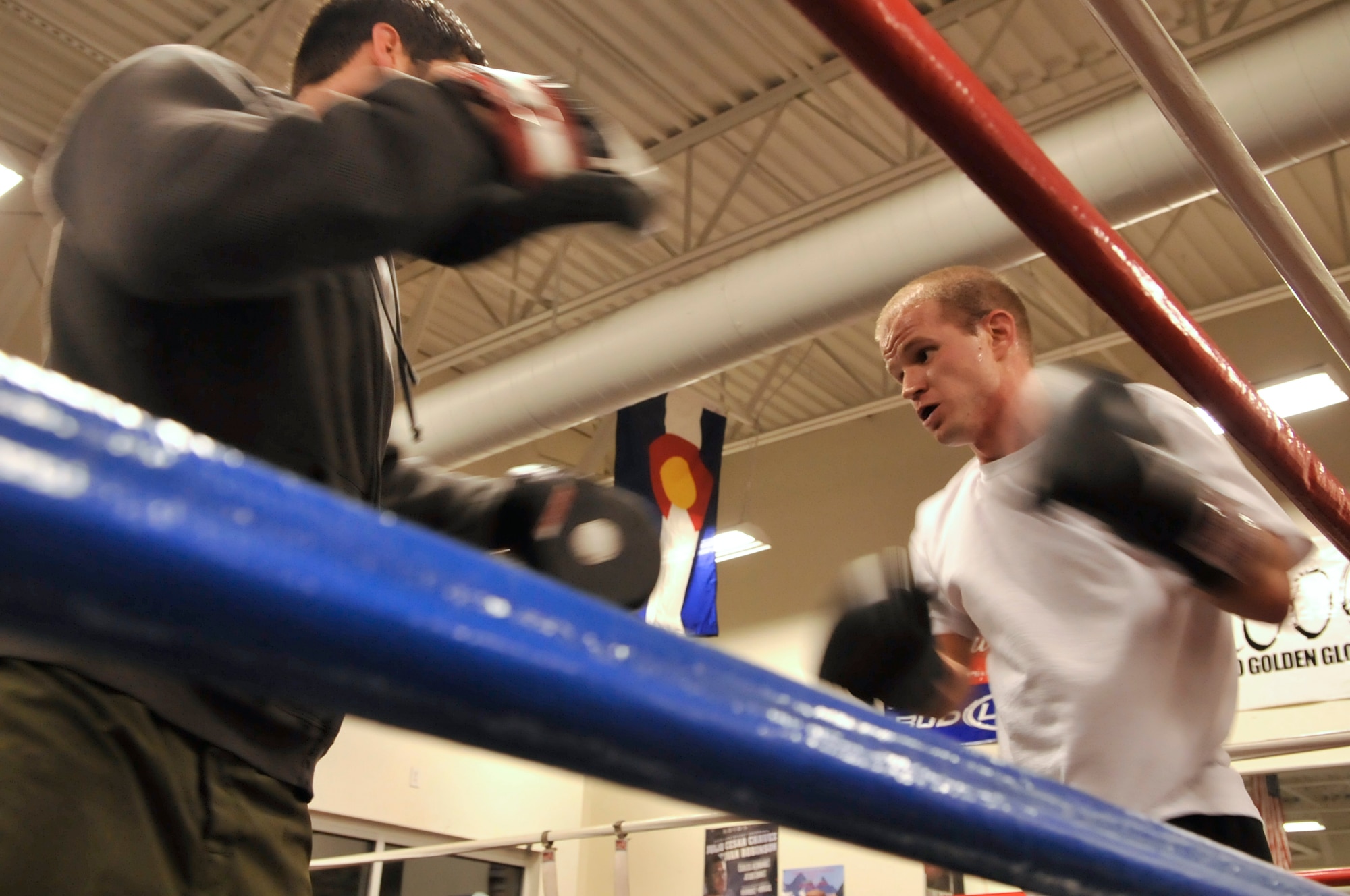 AURORA, Colo. -- Staff Sgt. Joshua Hinton, Air Reserve Personnel Center Directorate of Communications and Information knowledge operations manager, right, trains in the ring with professional boxer and A1 Boxing trainer Terry Bergl Oct. 21. Boxing fitness programs are full body workouts that can burn 800 to 1,000 calories for every one hour session. (U.S. Air Force photo by Senior Airman Kathrine McDowell)