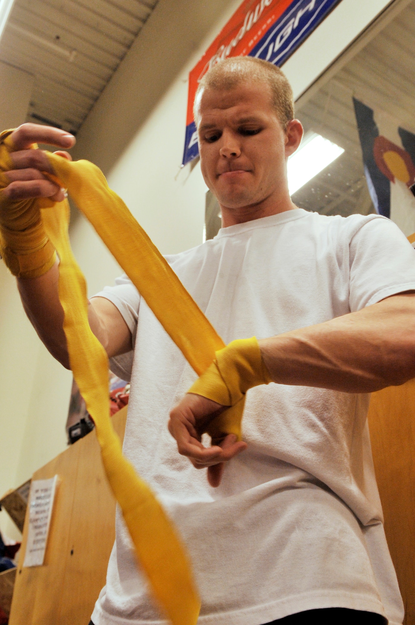 AURORA, Colo. -- Staff Sgt. Joshua Hinton, Air Reserve Personnel Center Directorate of Communications and Information knowledge operations manager, wraps his hands to prevent breaks and sprains Oct. 21. Boxing fitness programs are full body workouts that can burn 800 to 1,000 calories for every one hour session. (U.S. Air Force photo by Senior Airman Kathrine McDowell)