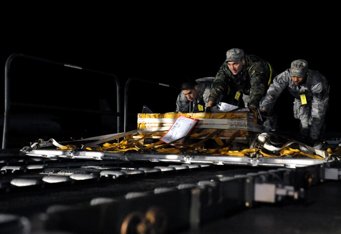 NELLIS AIR FORCE BASE, Nev. -- (from Left to right) Airman 1st Class Kaleb Salaza, Staff Sgt. Thomas Coffman and Staff Sgt. Daniel Limbrick, 99th Logistics Readiness Squadron, move cargo off of a Tunner 60K Aircraft Cargo Loader towards a deck during the Operational Readiness Inspection, Jan. 25. (U.S. Air Force photo by Airman 1st Class Brett Clashman)






















  












 











































  












 
























