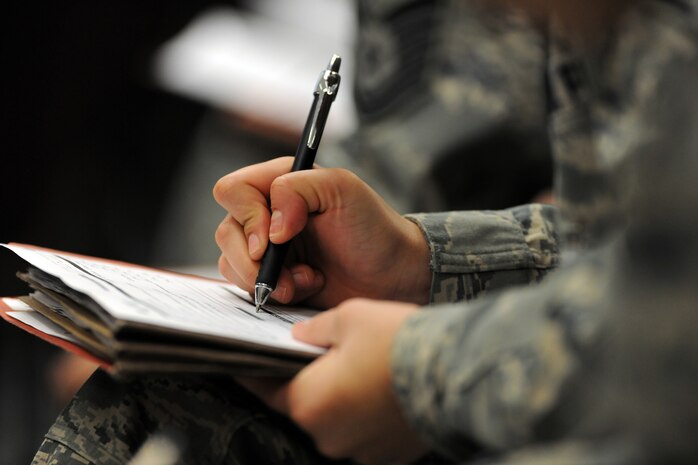NELLIS AIR FORCE BASE, Nev. -- Airmen in the Passenger Deployment Function briefing area complete pre-deployment paperwork during the 99th Air Base Wing Operation Readiness Inspection Jan. 25. (U.S. Air Force photo by Tech. Sgt. Michael R. Holzworth)