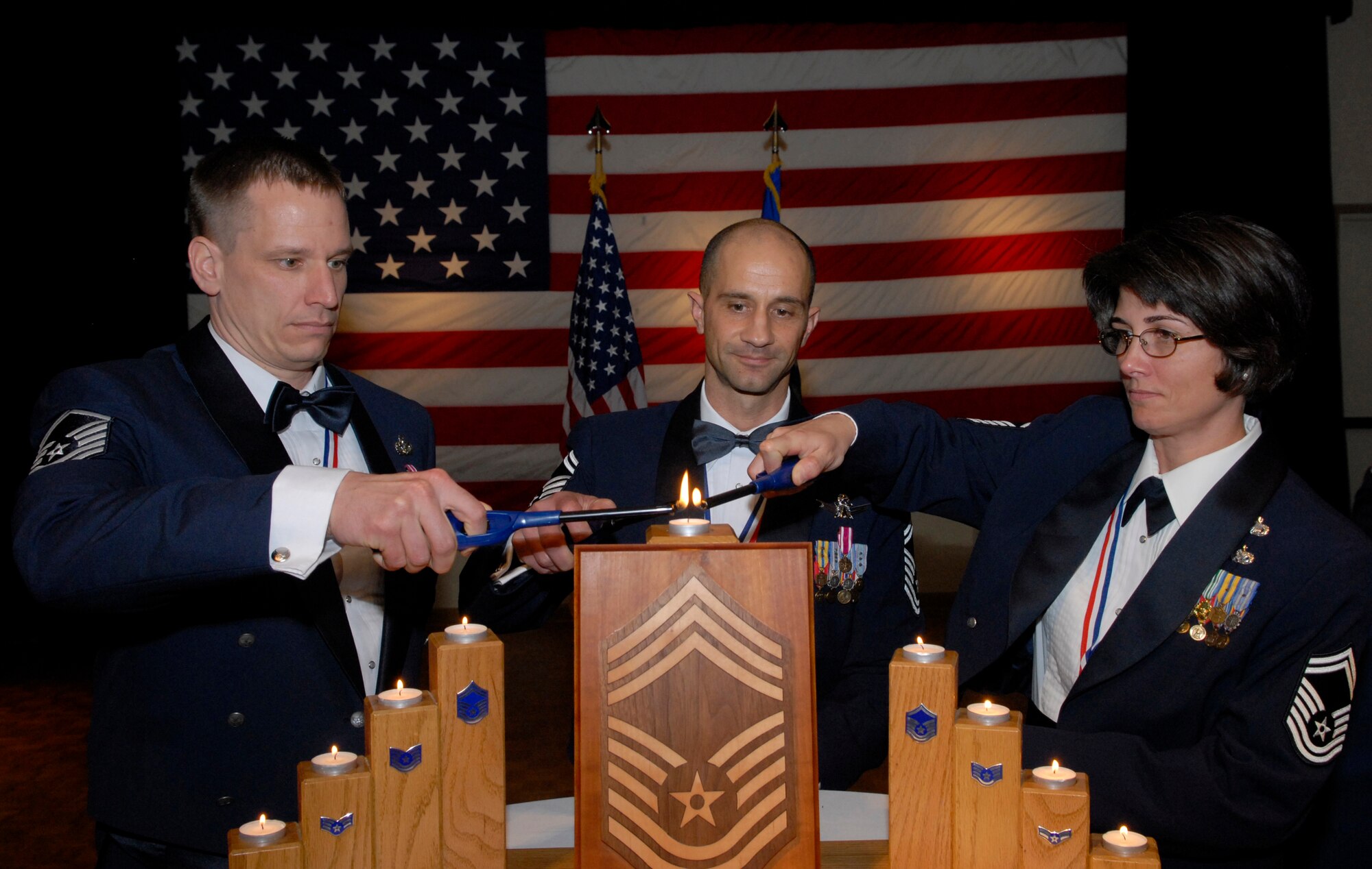 VANDENBERG AIR FORCE BASE, Calif. – Senior Master Sgt. Robert Rucinski, Senior Master Sgt. Frank Fidani and Senior Master Sgt. Alexia Brown light the chiefs’ candle together during the Chief Recognition Ceremony on Friday, Jan. 22, 2010, at the Pacific Coast Club here. All three Airmen were recently selected for promotion to chief master sergeant. (U.S. Air Force photo/Senior Airman Ashley Reed)