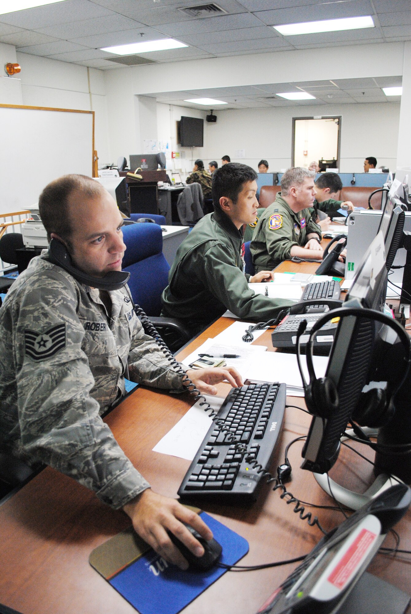 Tech. Sgt. Charles Roberts coordinates airspace requirements with his Japan Air Self-Defense Force counterpart, 1st Lt. Keisuke Nakajima, during Keen Edge '10 Jan. 25, 2010, at Yokota Air Base, Japan. Exercise participants practice responding to various events to increase combat readiness and interoperability of U.S. forces and Japan Self-Defense Forces. Sergeant Roberts is a Keen Edge combat airspace manager from the 374th Operations Support Squadron. (U.S. Air Force photo/Capt. Will Powell)