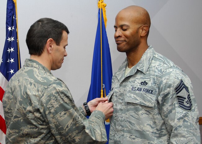NELLIS AIR FORCE BASE, Nev.-- Col. John P. Montgomery, 98th Range Wing commander, presents Chief Master Sgt. Mark T. Darden, 98th Range Wing superintendent, with a Bronze Star Jan. 14 for his meritorious achievement while deployed to Joint Base Balad, Iraq and Al Udeid Air Base, Qatar.  Chief Darden served as the Chief Enlisted Manager for the 557th Expeditionary RED HORSE Squadron, 9th Air Expeditionary Task Force from Sep. 13, 2008 to April 1, 2009.  (U.S Air Force photo by Staff Sgt Taylor Worley)