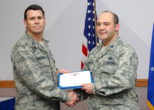 NELLIS AIR FORCE BASE, Nev.-- Col. John P. Montgomery, 98th Range Wing commander, presents Lt. Col. Tony L. Millican, 98th Mission Support Group deputy commander, with a Bronze Star Jan. 13 for his meritorious service while deployed to Kabul, Afghanistan.  Colonel Millican  served as the commander of the United States National Support Element, Headquarters International Security Assistance Force from March 1 to Sept. 1. (U.S Air Force photo by Staff Sgt Taylor Worley)