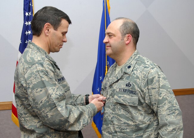 NELLIS AIR FORCE BASE, Nev.-- Col. John P. Montgomery, 98th Range Wing commander, presents Lt. Col. Tony L. Millican, 98th Mission Support Group deputy commander, with a Bronze Star Jan. 13 for his meritorious service while deployed to Kabul, Afghanistan.  Colonel Millican served as the commander of the United States National Support Element, Headquarters International Security Assistance Force from March 1 to September 1. (U.S Air Force photo by Staff Sgt. Taylor Worley)