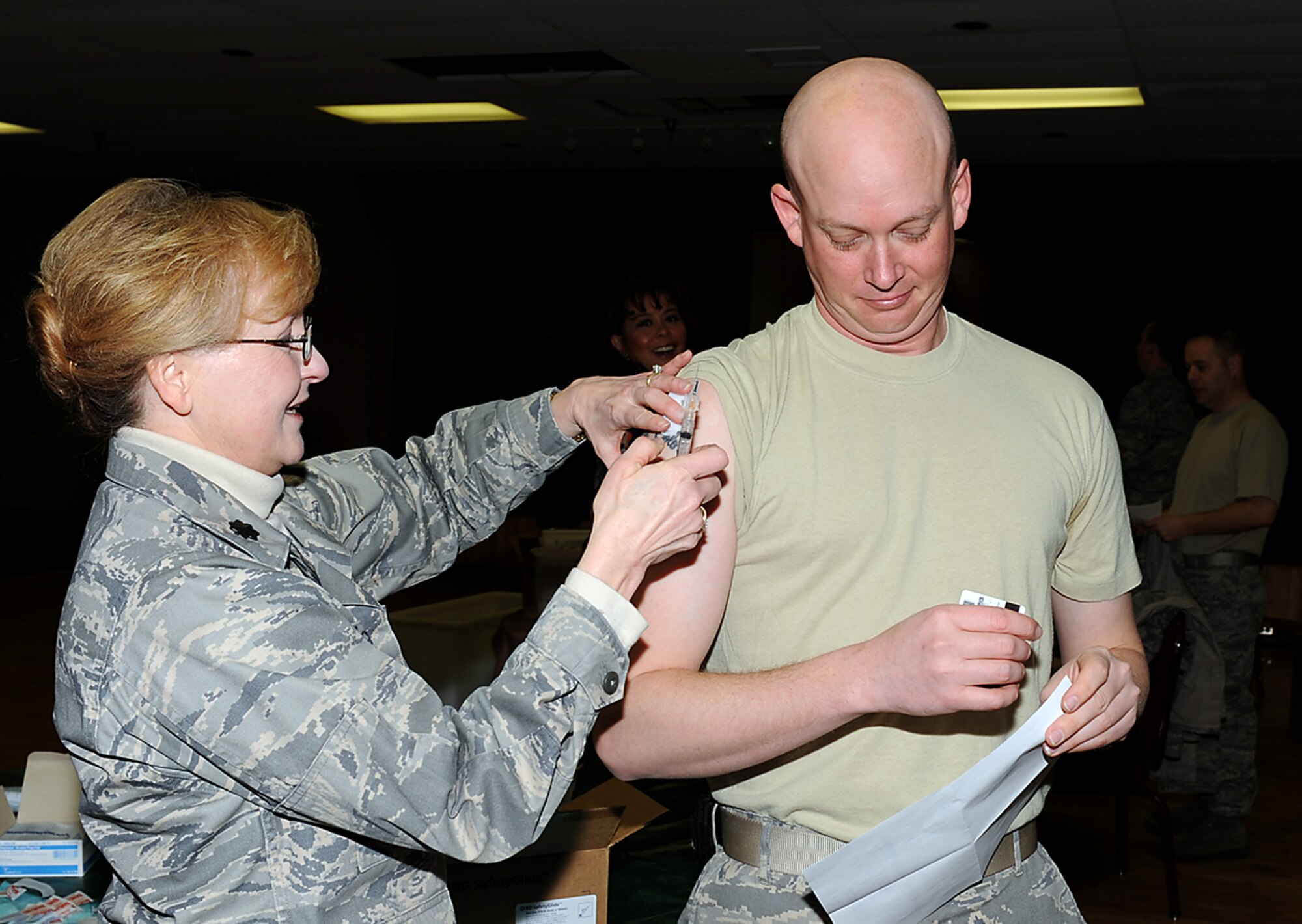 PETERSON AIR FORCE BASE, Colo. -- Lt. Col. Wanda McFatter, 21st Medical Operations Squadron commander, administers an H1N1 vaccination to Tech. Sgt. Joseph Beymer, 561st Network Operations Squadron Jan. 15 in Building 725. The H1N1 shots were available for active duty Airmen, and were administered at Buildings 1, 2, 3 and 725. In total, approximately 2,150 servicemembers received the vaccinations. The medical group also has the vaccine available to all TriCare beneficiaries, call 556-1118 for information. (Air Force photo by Roberta McDonald)