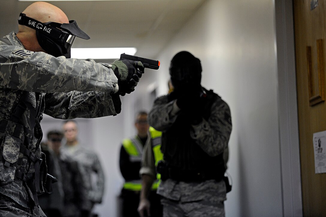 ELLSWORTH AIR FORCE BASE, S.D. -- (Left) Staff Sgts. Joseph Vawter and Alston Alexander, 28th Security Forces Squadron team members, clear a room during an armed threat exercise, Jan. 25. Airmen received specific training from the Pennington County Sheriff’s Department special response team to neutralize the threat as quickly as possible. (U.S. Air Force photo/Airman 1st Class Matthew Flynn)
