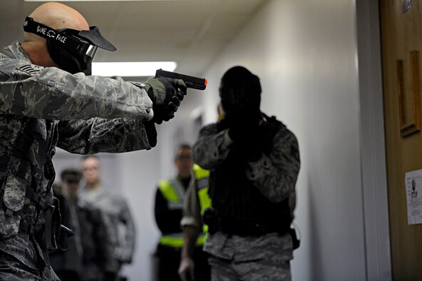 ELLSWORTH AIR FORCE BASE, S.D. -- (Left) Staff Sgts. Joseph Vawter and Alston Alexander, 28th Security Forces Squadron team members, clear a room during an armed threat exercise, Jan. 25. Airmen received specific training from the Pennington County Sheriff’s Department special response team to neutralize the threat as quickly as possible. (U.S. Air Force photo/Airman 1st Class Matthew Flynn)