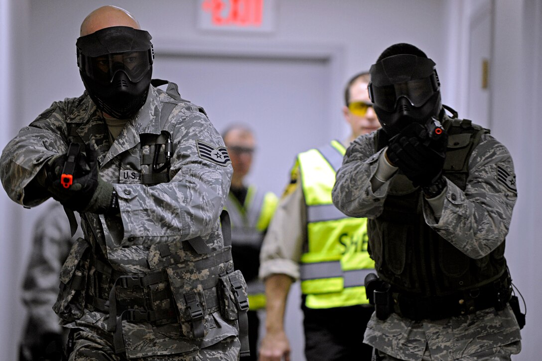 ELLSWORTH AIR FORCE BASE, S.D. -- (Left) Staff Sgts. Joseph Vawter and Alston Alexander, 28th Security Forces Squadron team members, maneuver through a hallway and clear rooms during tactical training, Jan. 25. The Pennington County Sheriff’s Department special response team gave 28 SFS team members specific training on various armed threat scenarios. (U.S. Air Force photo/Airman 1st Class Matthew Flynn)