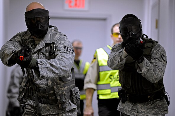 ELLSWORTH AIR FORCE BASE, S.D. -- (Left) Staff Sgts. Joseph Vawter and Alston Alexander, 28th Security Forces Squadron team members, maneuver through a hallway and clear rooms during tactical training, Jan. 25. The Pennington County Sheriff’s Department special response team gave 28 SFS team members specific training on various armed threat scenarios. (U.S. Air Force photo/Airman 1st Class Matthew Flynn)
