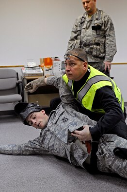 ELLSWORTH AIR FORCE BASE, S.D. -- Sgt. Mike Ghents, Pennington County Sheriff's Department school liason officer, reviews an armed threat scenario with 28th Security Forces Squadron team members, Jan. 25. Officers from the Pennington County Sheriff’s Department provided 28 SFS personnel multiple scenarios to help Airmen understand and develop tactics against them. (U.S. Air Force photo/Airman 1st Class Matthew Flynn)