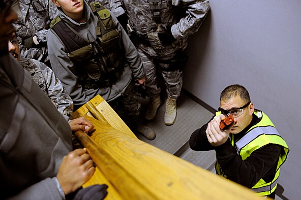 ELLSWORTH AIR FORCE BASE, S.D. -- Sgt. Mike Ghents, Pennington County Sheriff’s Department school liason officer, demonstrates the proper way to clear a stairwell to members of the 28th Security Forces Squadron, Jan. 25. The Pennington County Sheriff’s Department special response team gave 28 SFS team members precise training on various armed threat scenarios. (U.S. Air Force photo/Airman 1st Class Matthew Flynn)