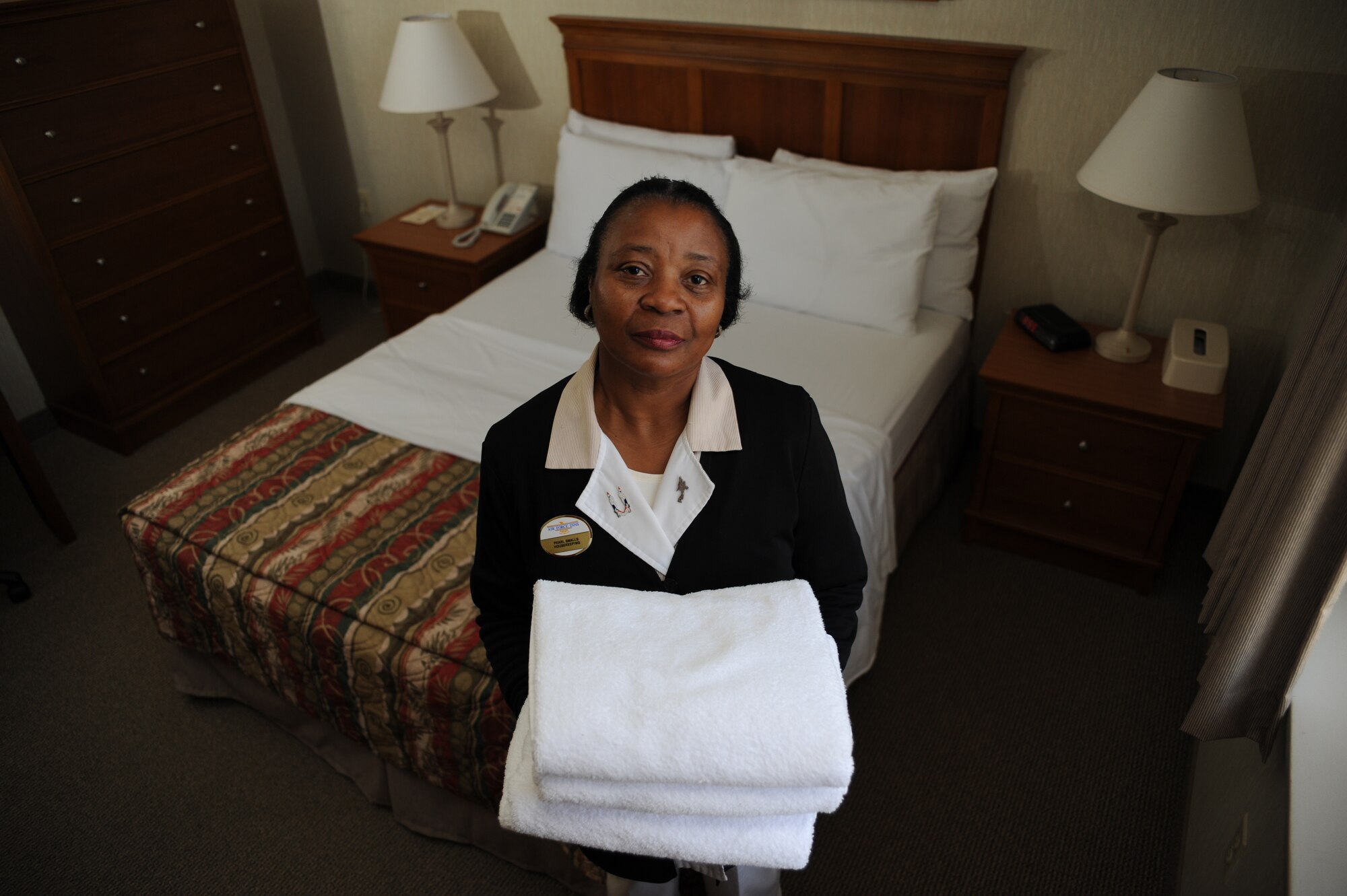 Pearl Smalls takes a moment to pose for a photo Jan. 26. As a housekeeper her daily duties include cleaning rooms and accommodating customers, as well as making sure customers have everything they need. Since the disaster in Haiti Mrs. Smalls has had an increase in her workload because of the influx of aircrews staying at billeting. Mrs. Smalls stated that she is very honored knowing that she can play a part in the mission. (U.S. Air Force photo/Senior Airman Katie Gieratz)(RELEASED)