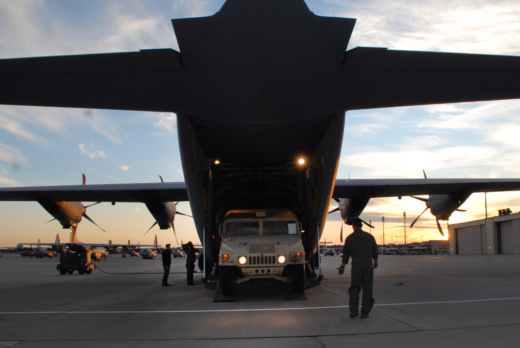 Tech. Sgt. Steve Nader, 34th Combat Training Squadron loadmaster, loads an Army Humvee, onto a 41st Airlift Squadron C-130J bound for Haiti at Pope Air Force Base, N.C. Jan. 19. The Airmen and aircraft were sent in support of Operation Unified Response, a relief effort to help the victims of the recent earthquake in Haiti. (U.S. Air Force photo by Capt. Joe Knable)