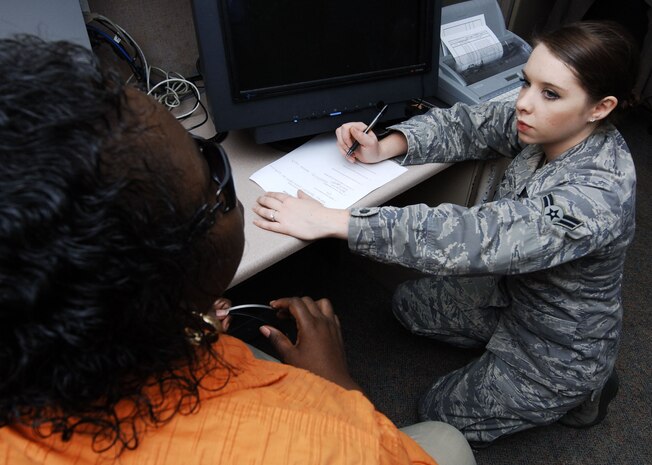 Airman 1st Class Lauren Main interviews Katina Gadsden Jan. 25 for an upcoming story on Charleston AFB's role in supporting Operation Unified Response. Airman Main is one of many public affairs personnel who work to ensure the Air Force's role in supporting Haitian relief efforts is properly documented and reported. Airman Main is a still photographer with the 628th Air Base Wing Public Affairs Office and Gadsden is a base operator with the 628th Communications Squadron. (U.S. Air Force photo/Staff Sgt. Barry Loo)