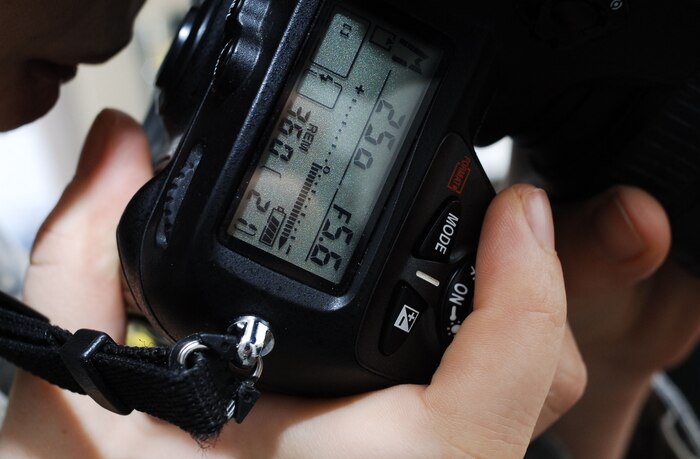 Airman 1st Class Lauren Main photographs a scene Jan. 25 for an upcoming story on Charleston AFB's role in supporting Operation Unified Response. Airman Main is one of many public affairs personnel who work to ensure the Air Force's role in supporting Haitian relief efforts is properly documented and reported. Airman Main is a still photographer with the 628th Air Base Wing Public Affairs Office. (U.S. Air Force photo/Staff Sgt. Barry Loo)