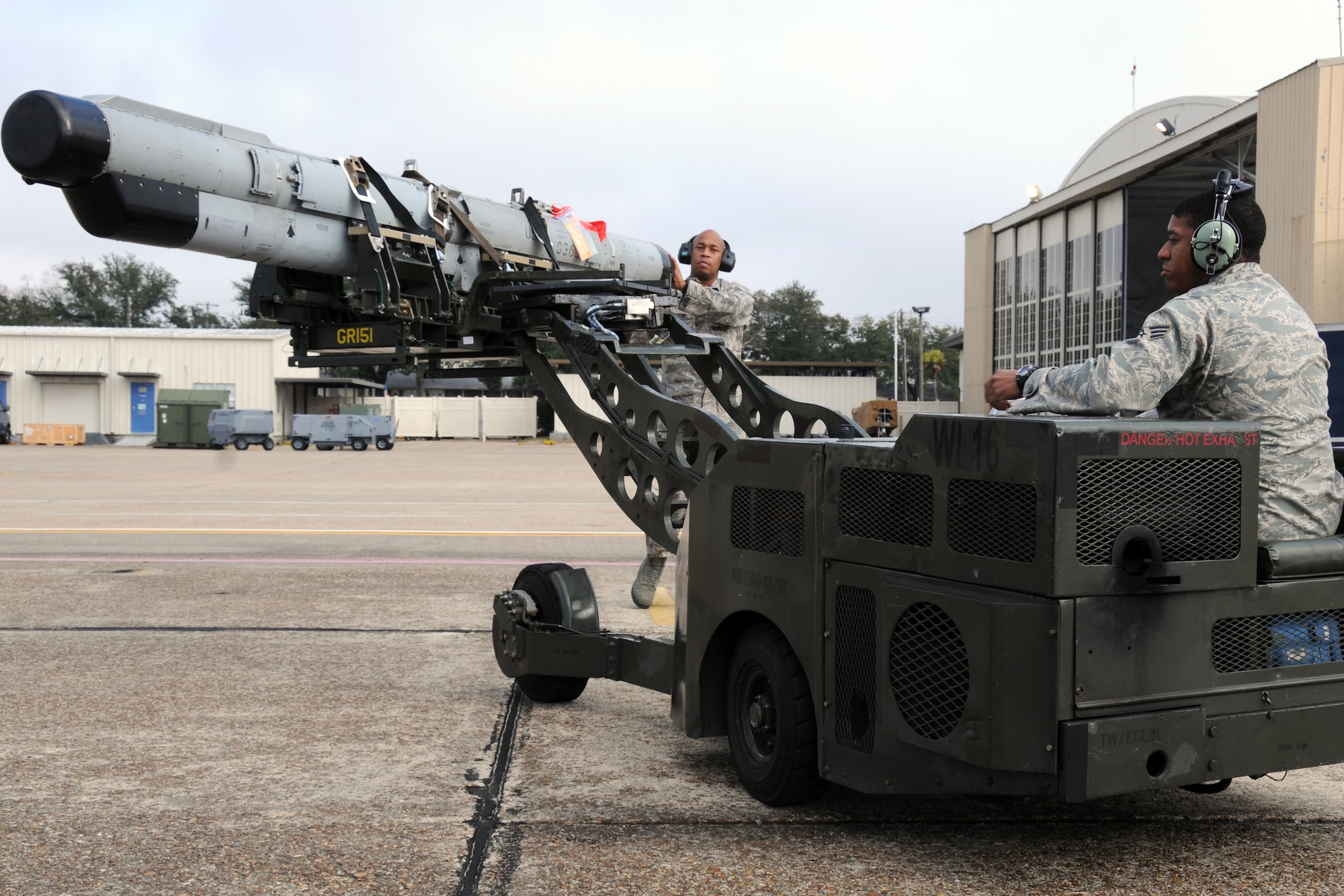 EGLIN AIR FORCE BASE, Fla. -- Tech. Sgt. Jerome Winston and Senior Airman Durral Mason, 16th Electronic Warfare Squadron, transport an electronic counter measures pod to be attached to an F-16 Fighting Falcon. The 16th EWS tests and delivers information that protects today’s warfighters from a multitude of threats. The squadron consists of four flights, a detachment and a cadre of individuals laying the foundation for the next generation of electronic warfare. (U.S. Air Force photo/ Airman 1st Class Anthony Jennings)