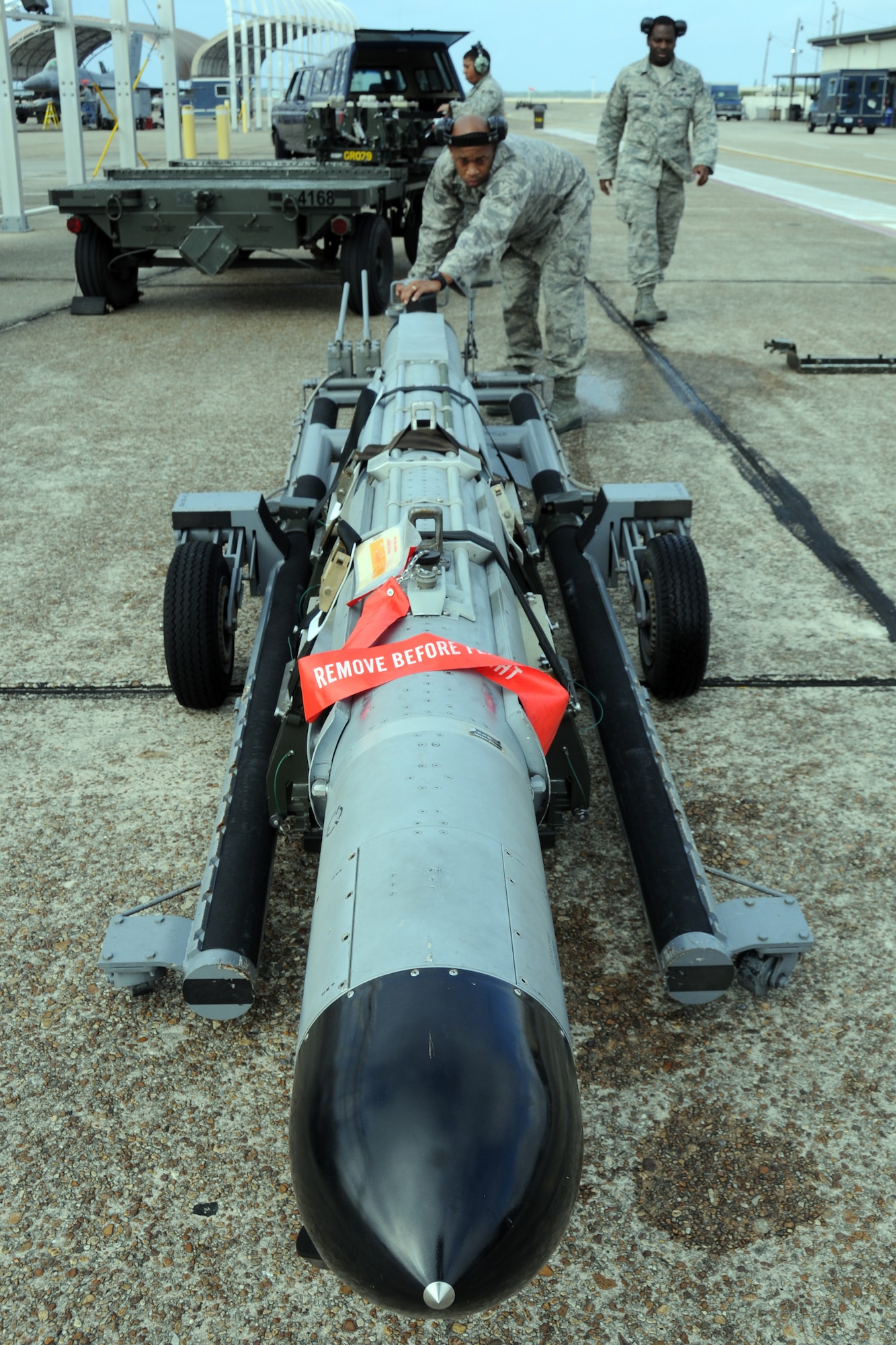 EGLIN AIR FORCE BASE, Fla. – Tech. Sgt. Jerome Winston, Staff Sgt. Tracy Lipscomb and Senior Airman Durral Mason, 16th Electronic Warfare Squadron, transport an electronic counter measures pod to be attached to an F-16 Fighting Falcon. The 16th EWS tests and delivers information that protects today’s warfighters from a multitude of threats. The squadron consists of four flights, a detachment and a cadre of individuals laying the foundation for the next generation of electronic warfare. (U.S. Air Force photo/ Airman 1st Class Anthony Jennings)